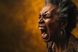 Closeup portrait, mad, angry, upset, hostile, senior african american mature woman, worker, furious employee, yelling, open mouth, yellow background. Negative human emotions, facial expression