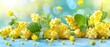  A bunch of yellow flowers with green leaves over a blue backdrop
