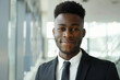 © Lazy_Bear - Confident black businessman wearing business suit in office workspace. Successful male business person portrait