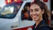 © ProPhotos - A female paramedic stands in front of an ambulance. She smiles with her hair braided in a ponytail.