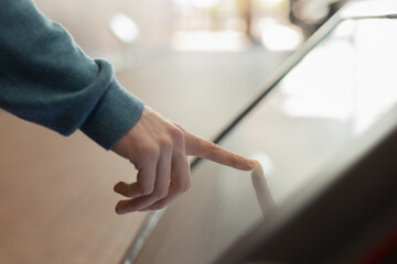 searching for information, male hand using multimedia kiosk, modern digital technology