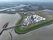 Aerial drone view on petroleum shipping terminal in the port of Terneuzen, The Netherlands. Storage laoding and unloading of liquid and gas energy products over seas and in land.