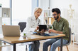 © sofiko14 - Mature specialist reading out electronic instruction for taking medication correctly. Senior female doctor and male patient sitting at table of modern medical center and watching together at tablet.