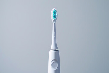 Wall Mural - Modern electric toothbrush on grey background