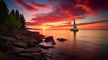 A Tranquil Scene With A Single Sailboat On A Calm Lake Under A Magnificent Sunset Sky The Rocky Shore And Pine Trees Add To The Natural Beauty