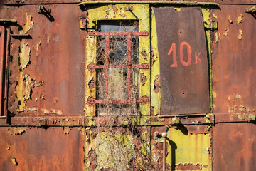 Wall Mural - Rusty and peeling paint wall of abandoned neglected railroad car closeup as colorful grunge background