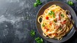 Delicious Carbonara pasta with Italian cheese, bacon, tomato, and parsley on a gourmet plate