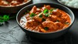 A bowl of Chicken Tikka Masala served with Indian spices and Basmati Rice