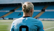 Greatest norwegian football player of all time wearing Manchester´s jersey. Back view of the best soccer striker standing in a stadium field