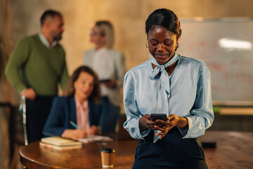 Confident multiracial businesswoman contacting clients during the meeting