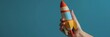 Wooden Rocket Held in Hand, Vibrant Colors