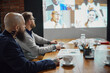 © master1305 - Team leader and project manager sitting in office and having online conference call with employees. Discussion of projects and working on tasks. Business, teamwork, cooperation with colleagues concept