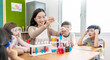 Diversity children student doing a chemical experiment in laboratory at school. Portrait of happy kids at elementary school learn science chemistry with asian teacher. Fun study back to school banner