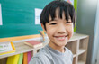Portrait of pupil boy, Learn in classroom at elementary school. Student boy studying primary school. Children coding online in classroom. Education knowledge modern multicultural school.