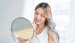 Closeup portrait young beautiful asian girl with mirror makeup routine with copy space. Beauty influencer woman perfect glow touch skin dress up. Healthcare woman lifestyle cosmetic blogger concept