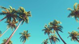 Fototapeta Natura - Low angle view of tropical palm trees over clear blue sky generative ai
