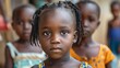children of nigeria, A young child with striking eyes stands in a group of peers, conveying innocence and curiosity. 