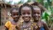 Children of Sierra Leone. Three smiling African children standing together in a village setting, exuding happiness and camaraderie