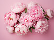 A banner showcases fresh pink and white peonies on a pink table in flat lay style