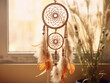 Dream catcher in beige and brown tones adds a touch of coziness to bedroom interior