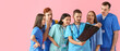 © Pixel-Shot - Group of medical students with x-ray scan on pink background