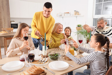 Wall Mural - Big family having dinner in kitchen