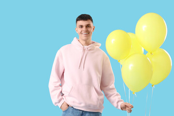 Sticker - Young man with bunch of balloons on blue background