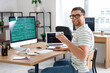 © Pixel-Shot - Portrait of male programmer with cup of coffee working in office