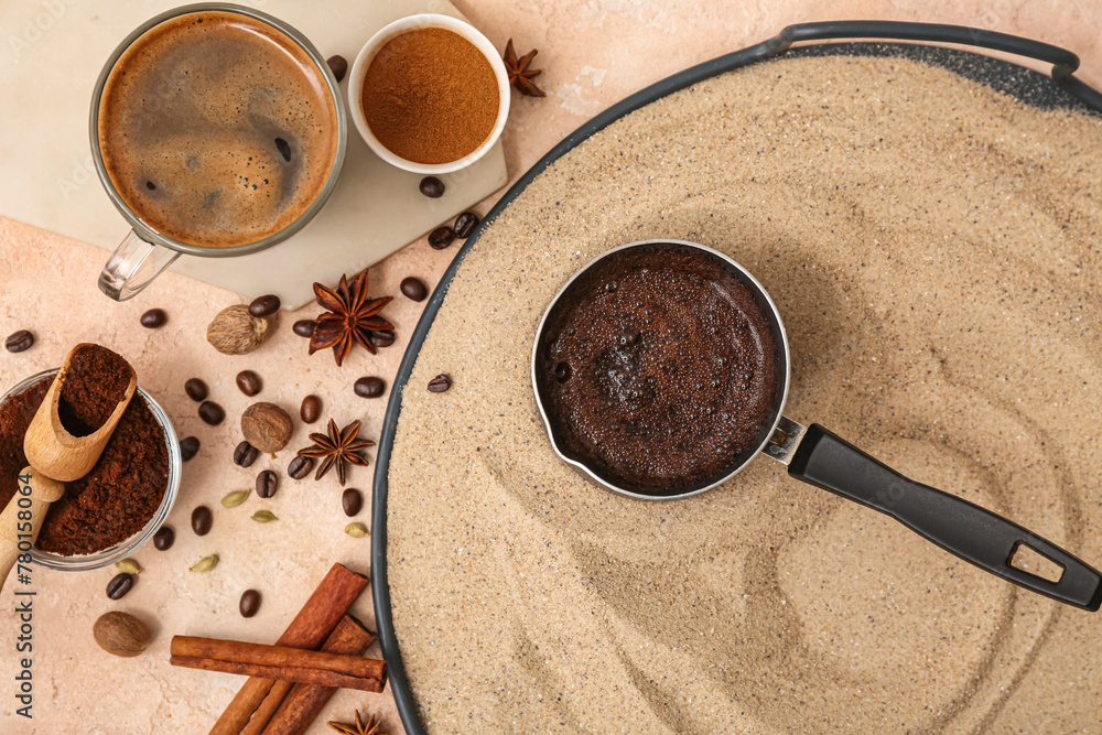 Aromatic Turkish coffee in sand, cup and different spices on light background