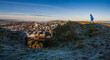 © Andrew Kornylak - A young man in a blue coat takes in a panoramic view from Arthur's Seat, a volcanic peak overlooking Edinburgh, Scotland.