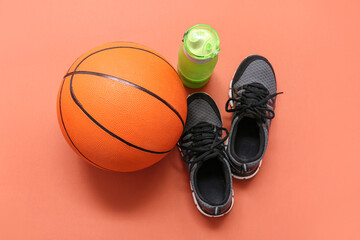 Wall Mural - Trainers, sport bottle and basketball on orange background