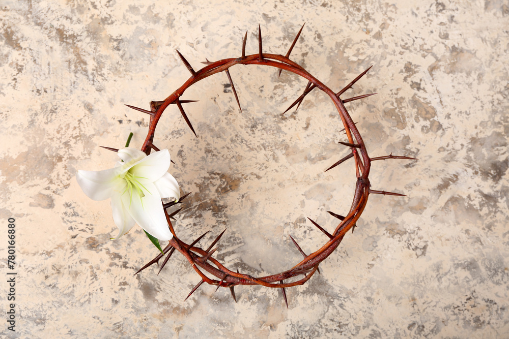 Crown of thorns with lily on light grunge background