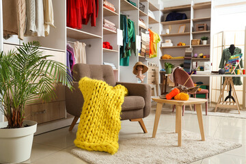 Poster - Interior of atelier with armchair, table and shelves