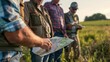 A group of farmers gather around a map discussing the placement of furrow irrigation systems in their biofuel cultivation fields. They carefully plan and strategize to ensure the most .