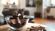 Chocolate bar in glasses bowl on wooden table at living room. Background for World chocolate day and chocolate cuisine.