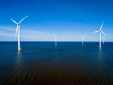 Fototapeta Uliczki - A group of wind turbines in the oceans surface in the Netherlands Flevoland