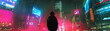 A man stands in the middle of a city with neon lights and signs