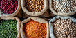 © Nice Seven - A top view of various shades and types of legumes in jute bags  on the table. different types of beans in bags, healthy and nutritious food