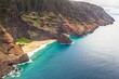 Beautiful aerial shot of the coast of Napali with clear beautiful water and steep rocks