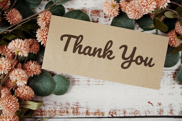 Canvas Print - Thank You text message on paper card with flowers border frame on wooden background