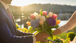 Wedding among mountains: hands with a bouquet of tulips