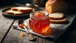 An intimate shot of a glass jar filled with homemade marmalade, with a silver spoon and slices of fresh bread in the background on a weathered kitchen.