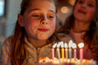 Girl blowing out birthday candles