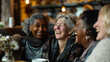 Joyful Multiethnic Senior Women Sharing a Laugh at a Cozy Cafe