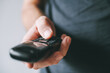 © Bits and Splits - Dialing cordless landline telephone device, closeup of male hand