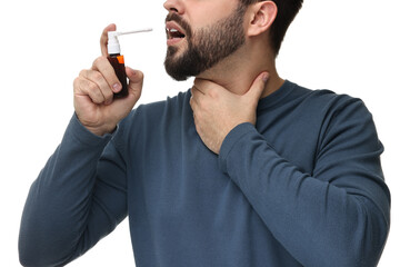 Canvas Print - Young man using throat spray on white background, closeup