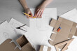 © New Africa - Woman creating packaging design at light wooden table, top view
