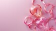 Two transparent heart-shaped objects with pink ribbons on a pink background