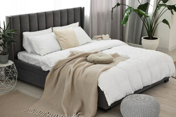 Sticker - Soft beige plaid on bed in stylish bedroom. Interior design