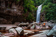 Serene Waterfall Oasis Amidst Rugged Rocks and Greenery